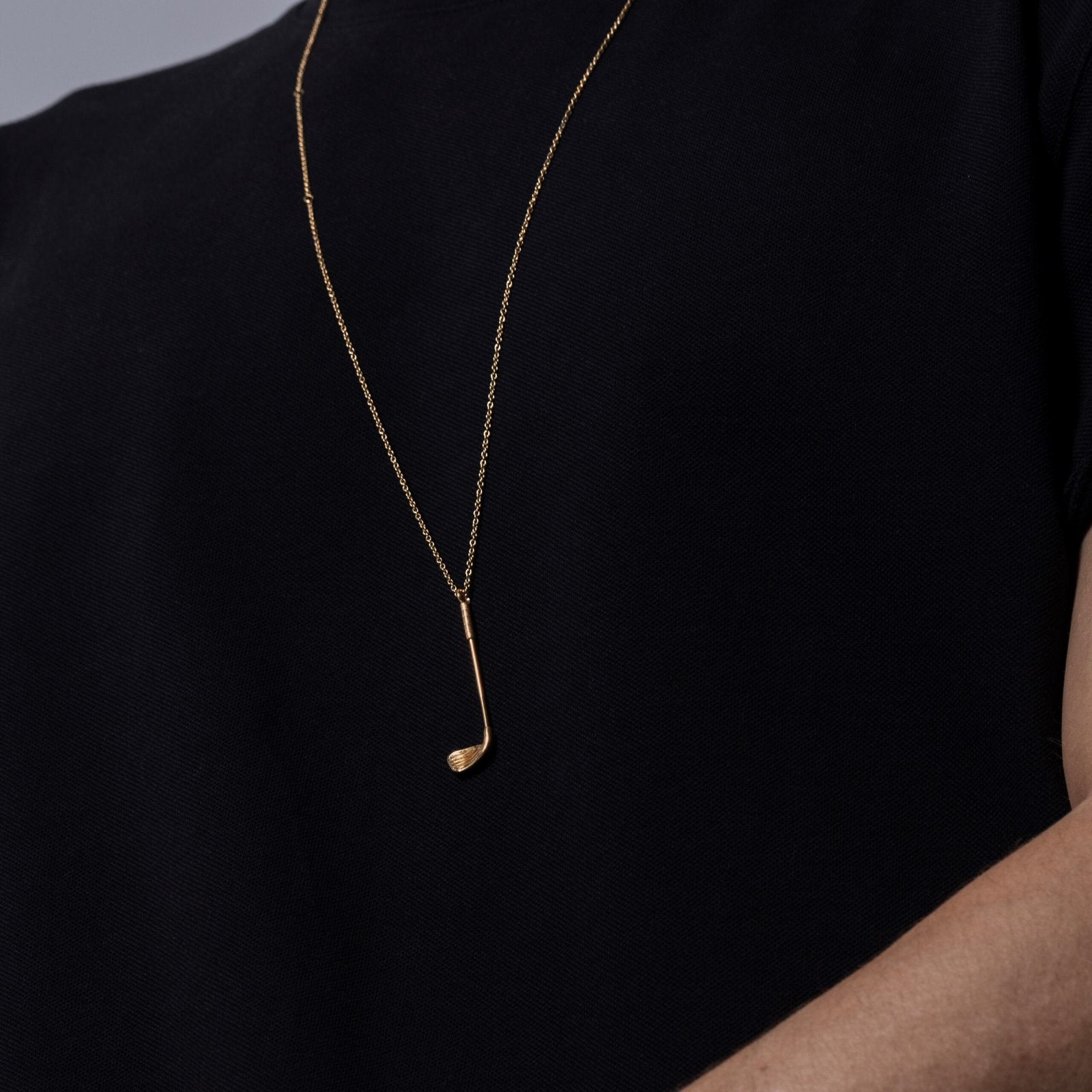 male model wearing Who's Your Caddy Gold – gold golf club locket necklace