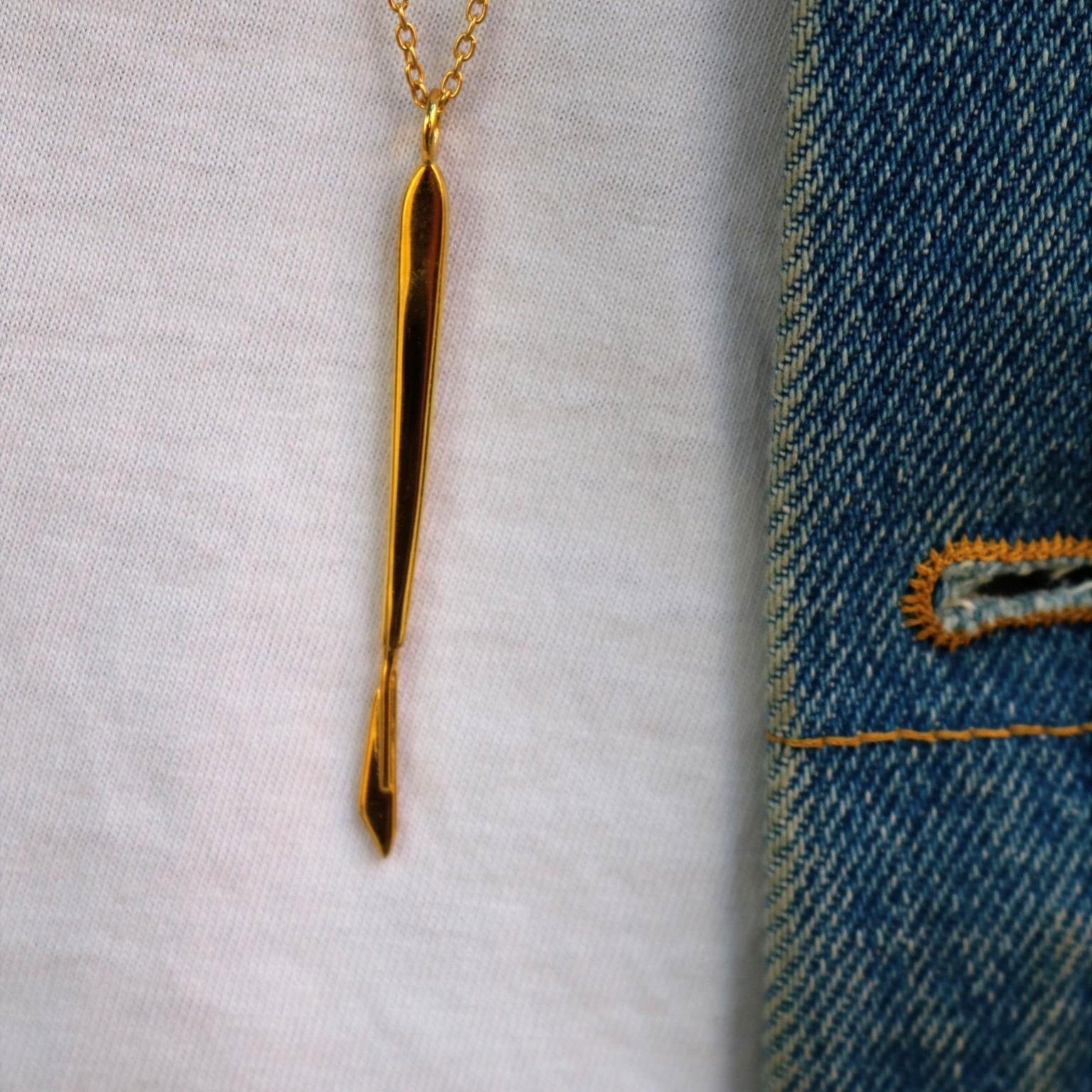 model wearing gold scalpel necklace – Scalpelle medicinal jewelry
