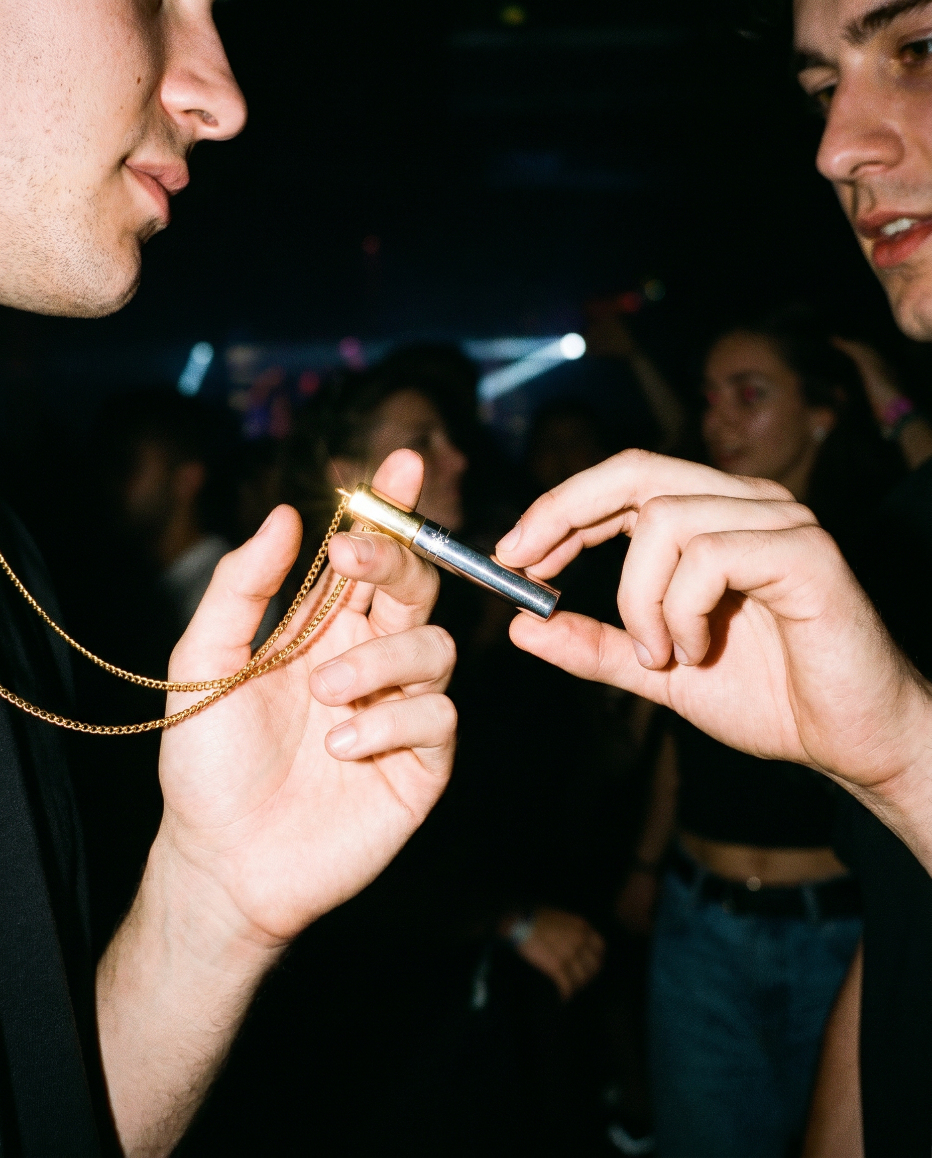people passing Taylor Snift – gold locket cigarette necklace - at a party in a club