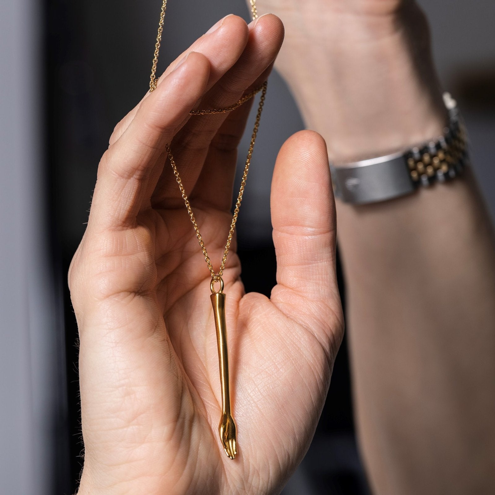 hand holding The Anglesea Arm Gold – gold stash spoon stash necklace
