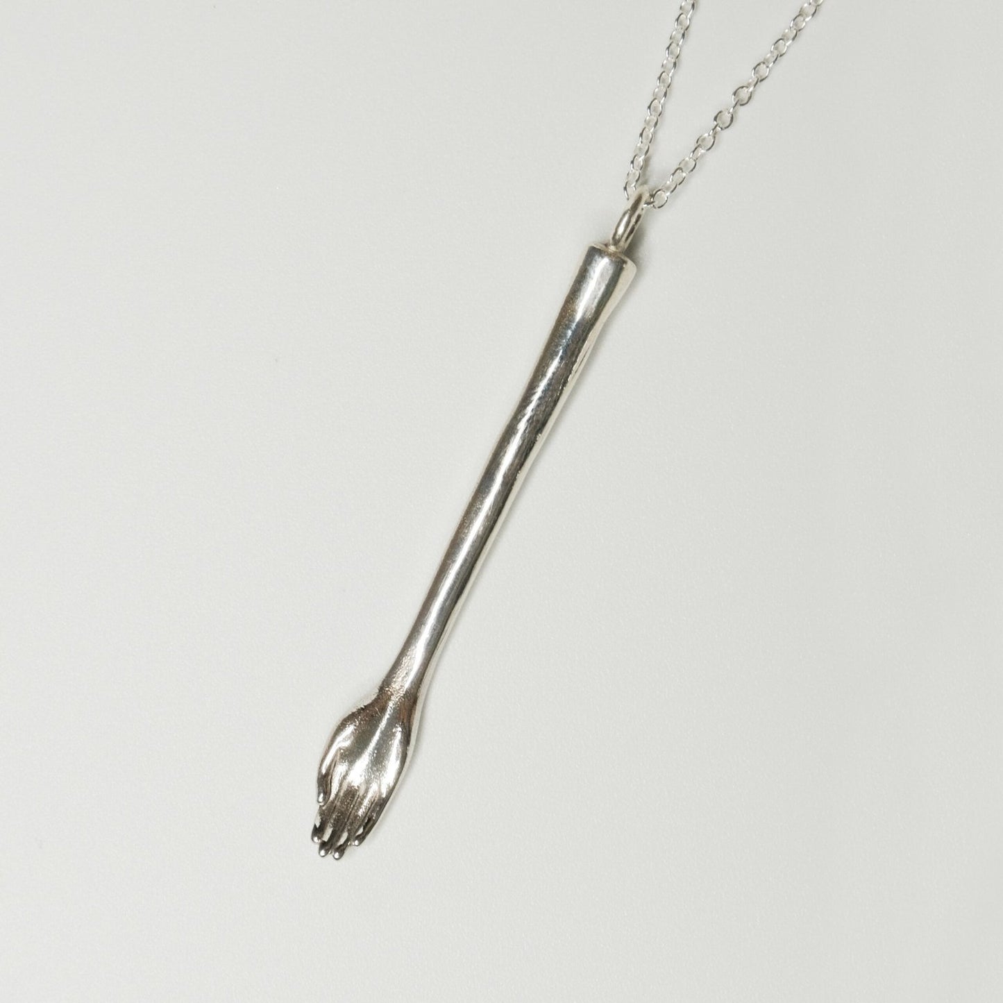 front view of The Anglesea Arm Silver – silver hand spoon necklace on chain