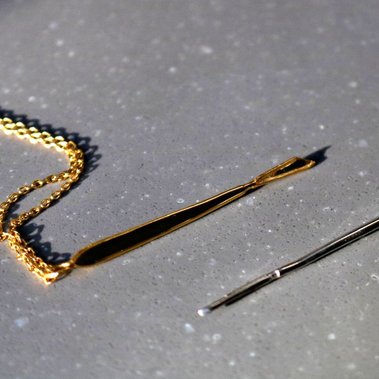 gold scalpel necklace flat lay – Scalpelle Gold jewelry